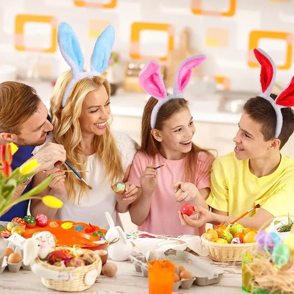A family of four laughing while wearing colorful bunny ear headbands during a party or cosplay event.
