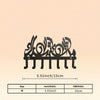 Black Islamic Arabic blessing key holder with hooks shown against a light background.