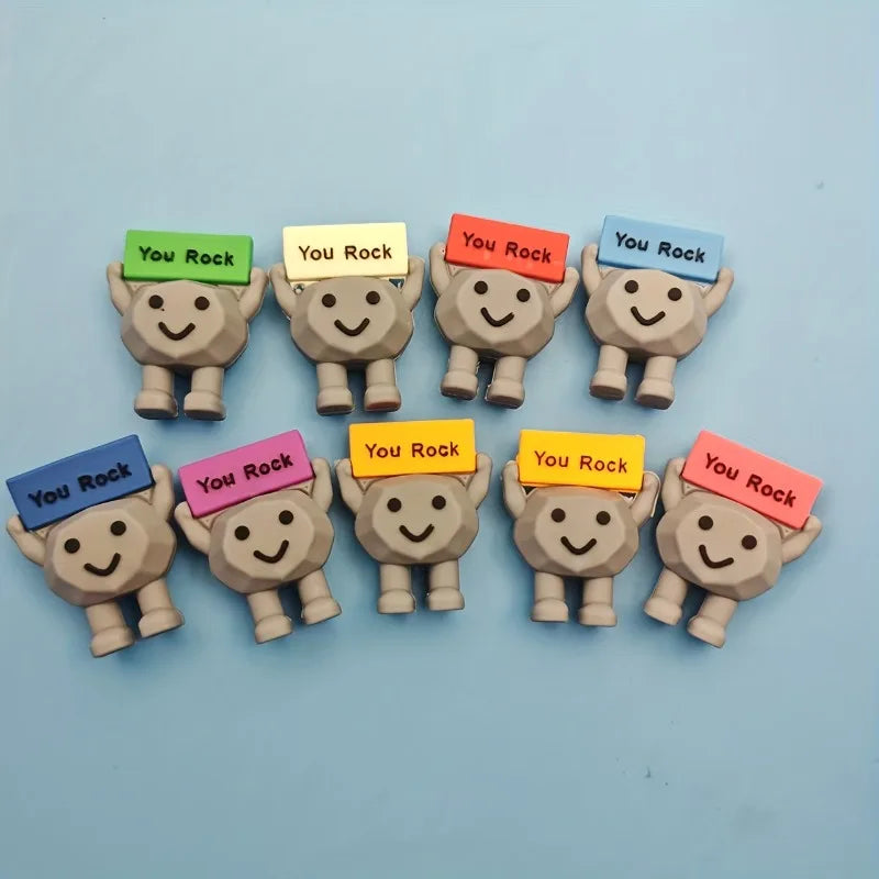 A collection of inspirational motivational stones shaped like bears, each with a colored tag displaying the message You Rock.