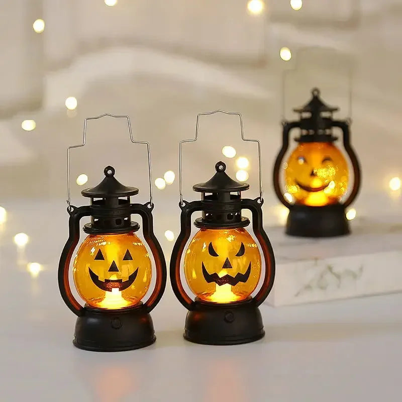 A pair of DIY Halloween pumpkin lanterns with an LED projection effect sitting on a white surface.