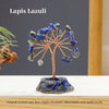 A crystal tree sculpture made of blue lapis lazuli stones with natural wire branches on a dark base.
