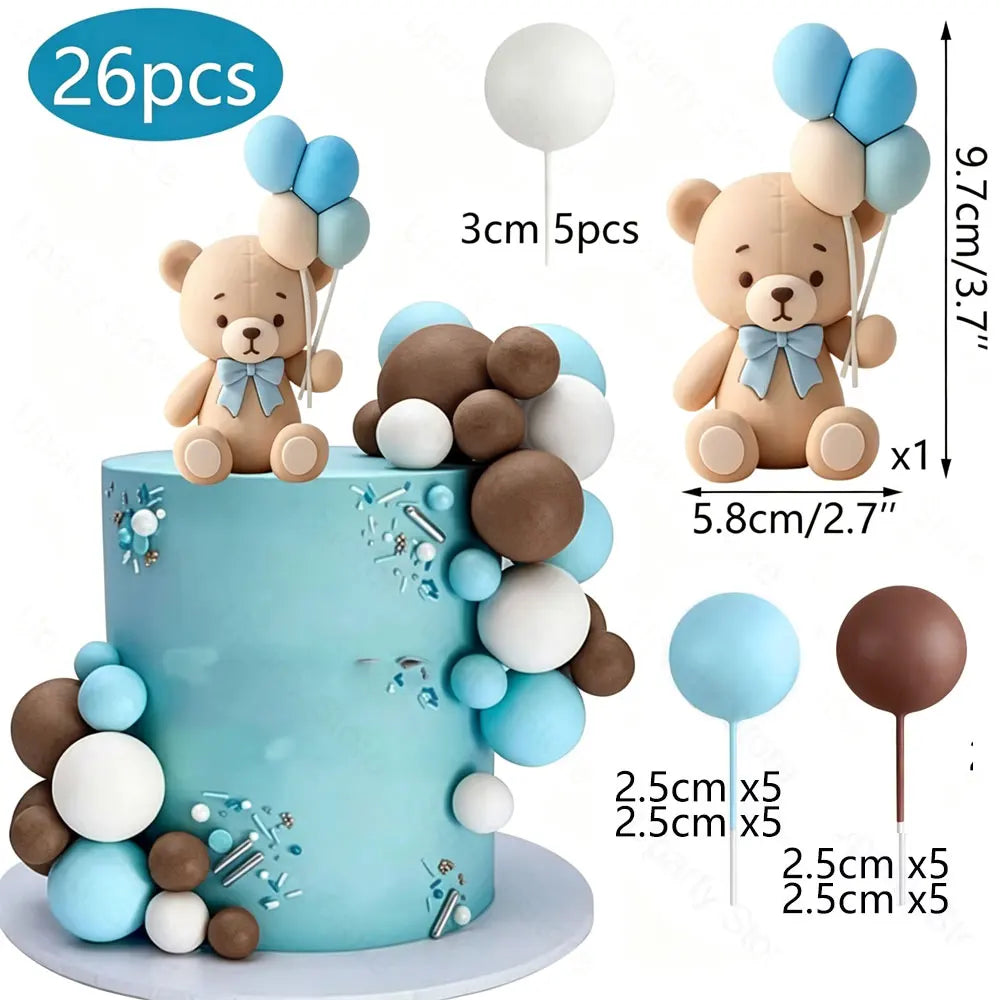 A tiered cake decorated with blue and brown foam balls and bear toppers, featuring light blue frosting.