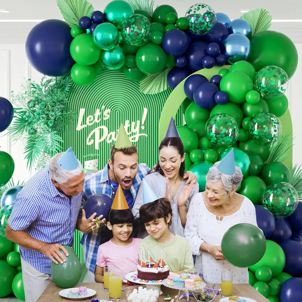 A colorful balloon arch set featuring green and purple balloons decorated with a birthday cake.