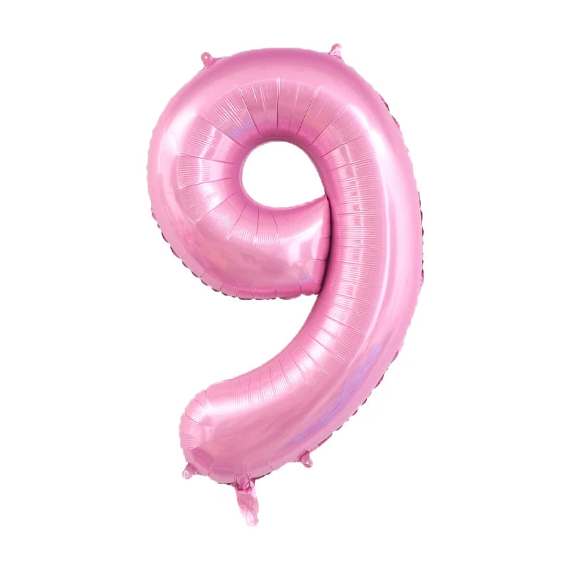 A large pink foil number balloon shaped like the number 9.