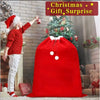 A young girl in a red sweater is reaching for a Christmas gift bag filled with festive red velvet items.