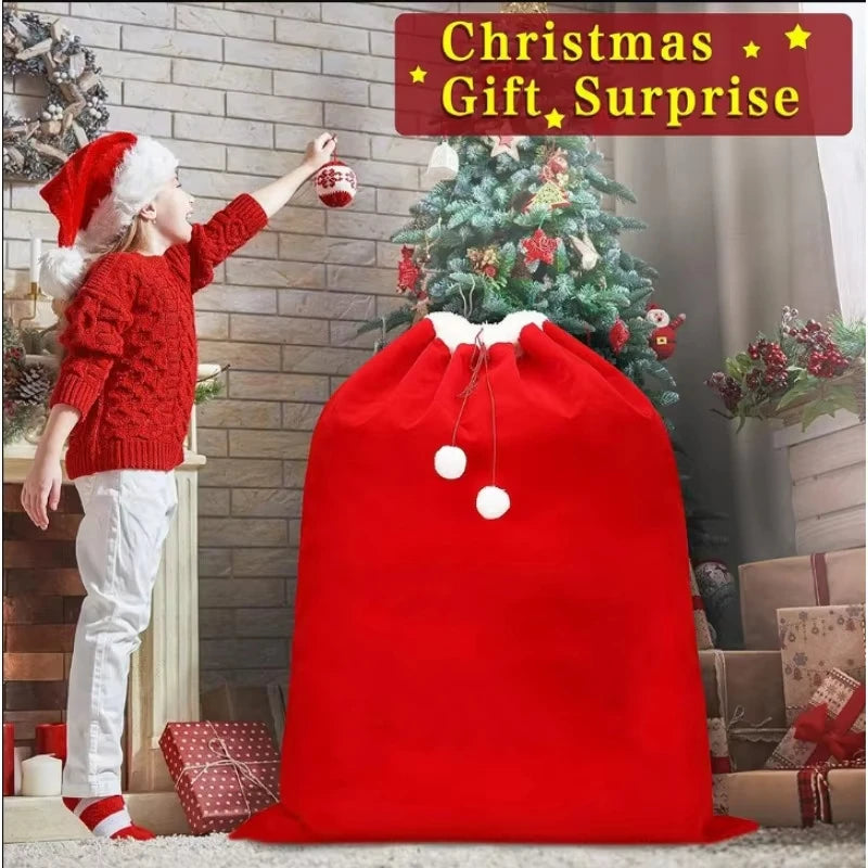 A young girl in a red sweater is reaching for a Christmas gift bag filled with festive red velvet items.