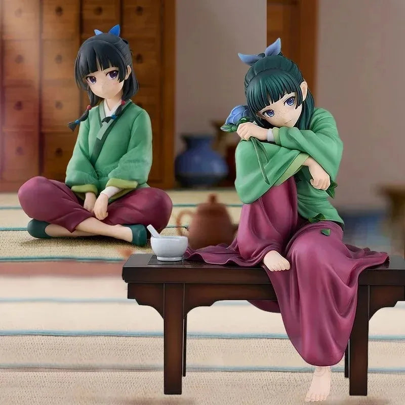 A collectible PVC figure of Maomao from The Apothecary Diaries, seated and dressed in green and purple robes.