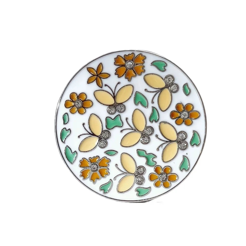 A decorative ceramic plate featuring floral crystal designs in orange, yellow, and green.