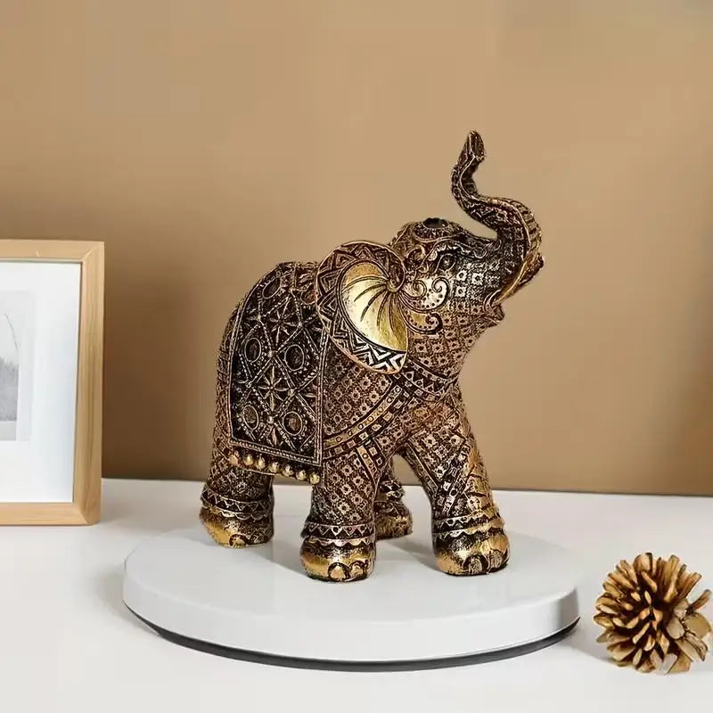 Vintage resin elephant ornament with gold detailing displayed on a white circular stand.