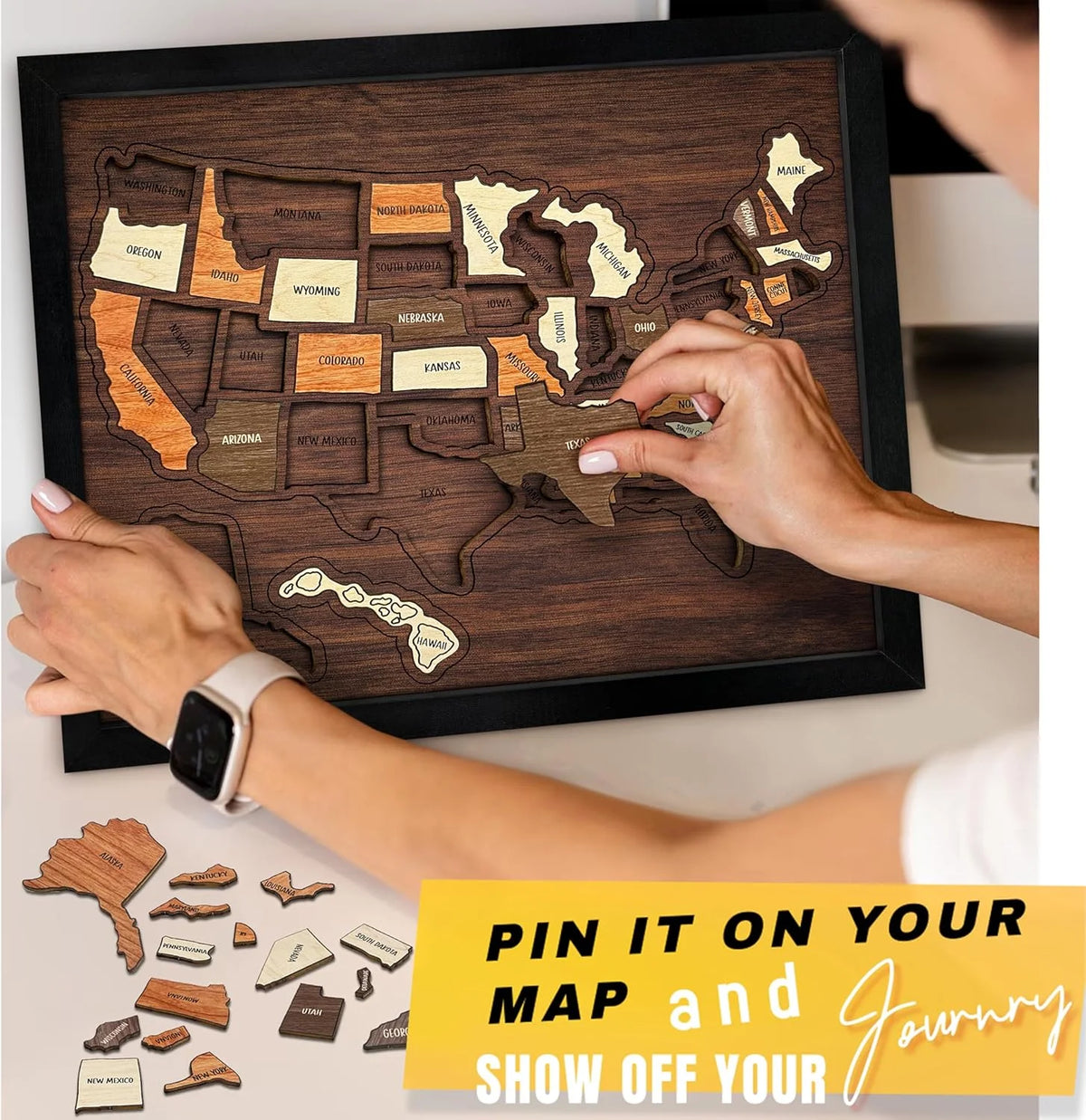 Hands are placing stickers onto a wooden USA travel map puzzle for a journey.