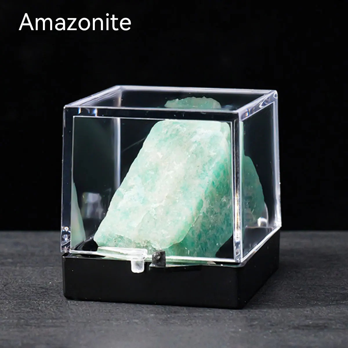 A clear box displays a large, translucent green amazonite crystal specimen.