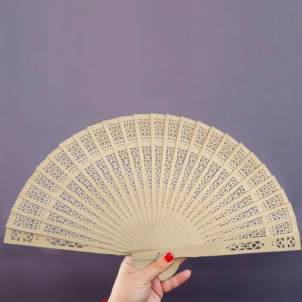 A set of twelve vintage wooden folding hand fans with intricate cutouts displayed against a gray background.