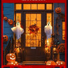 A dark door decorated for Halloween with glowing orange pumpkins and white ghost figures hanging on the entrance.