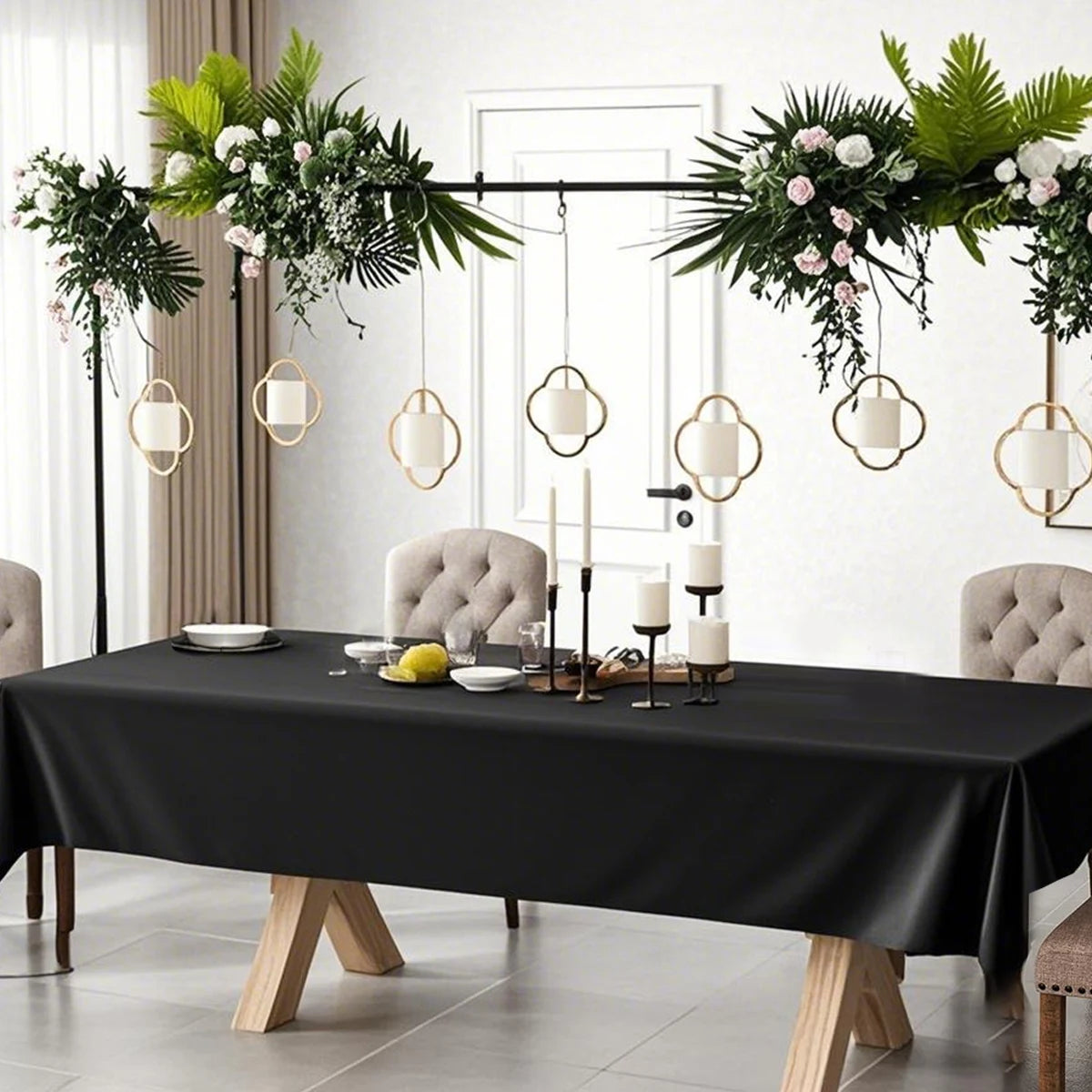Elegant black disposable plastic tablecloth set for weddings and parties displayed on a table.