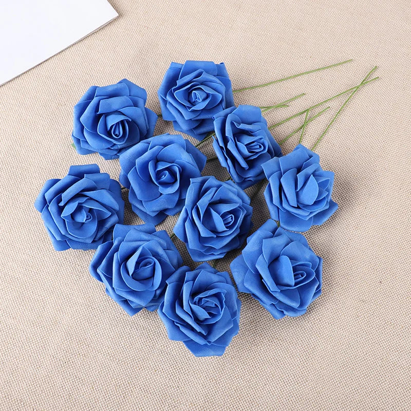 A cluster of twenty vibrant blue foam rose blooms on a beige fabric background.