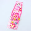 A pink beaded jewelry set for girls featuring a butterfly hair clip and various colorful beads.