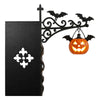 A black antique library lantern with a wrought iron bracket holding a carved pumpkin light.