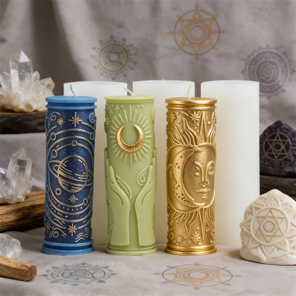 A collection of pillar candles featuring celestial and mystical symbols in blue, green, and gold.