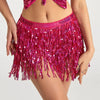 A model wears a sparkly magenta hula dancer skirt made of sequins with tassel belts.