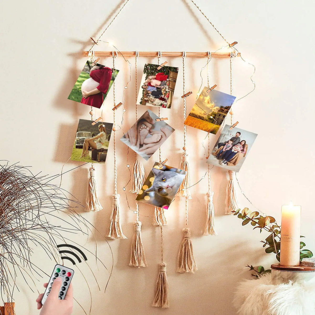 Boho macrame photo display featuring multiple framed photos hanging on a wooden rod against a light wall.