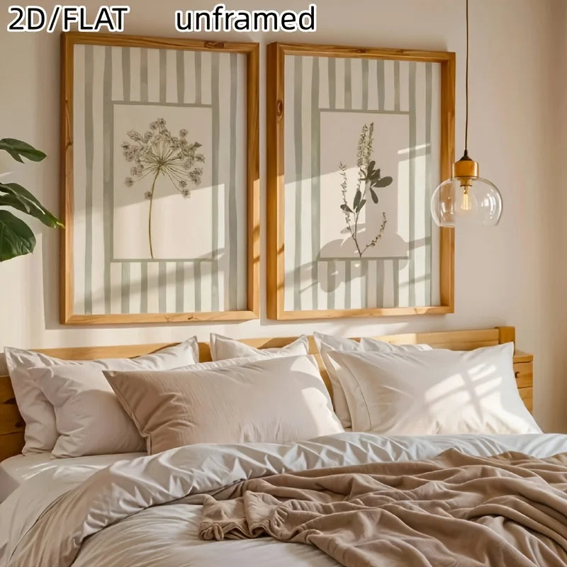 Two unframed canvas prints featuring delicate floral line art in sage green and white stripes displayed above a wooden bed.