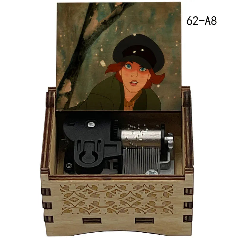 A hand-cranked wooden music box featuring a portrait of a woman in a dark hat, with internal mechanisms visible.