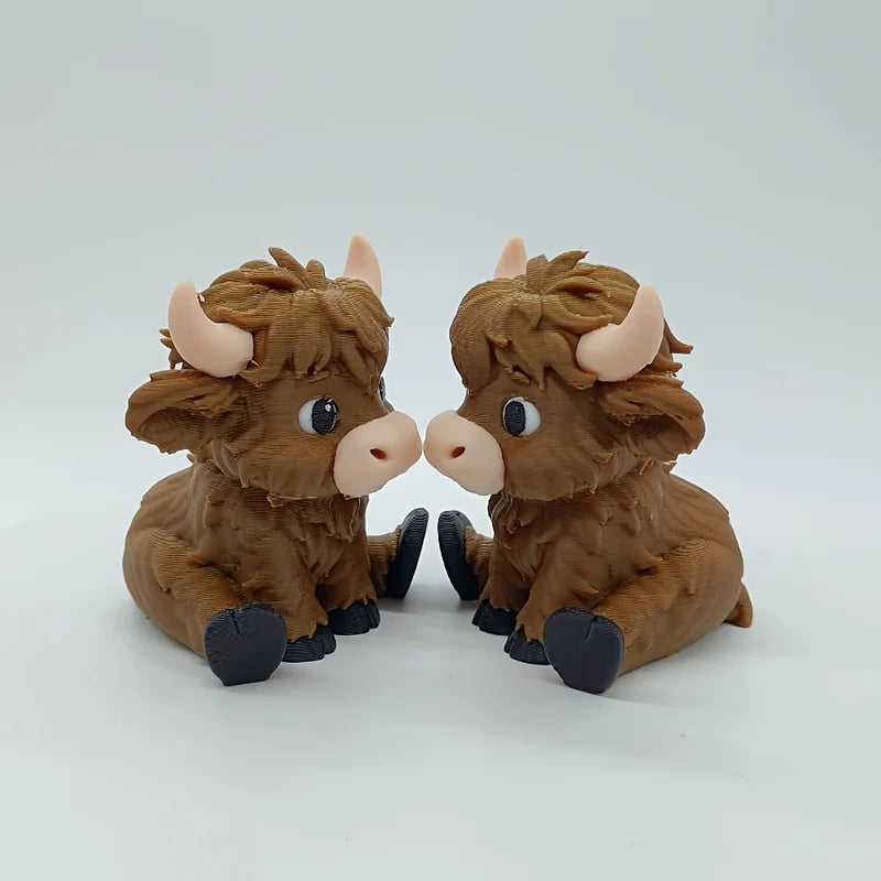 A small, brown Highland cow statue with horns and large eyes, displayed against a white background.