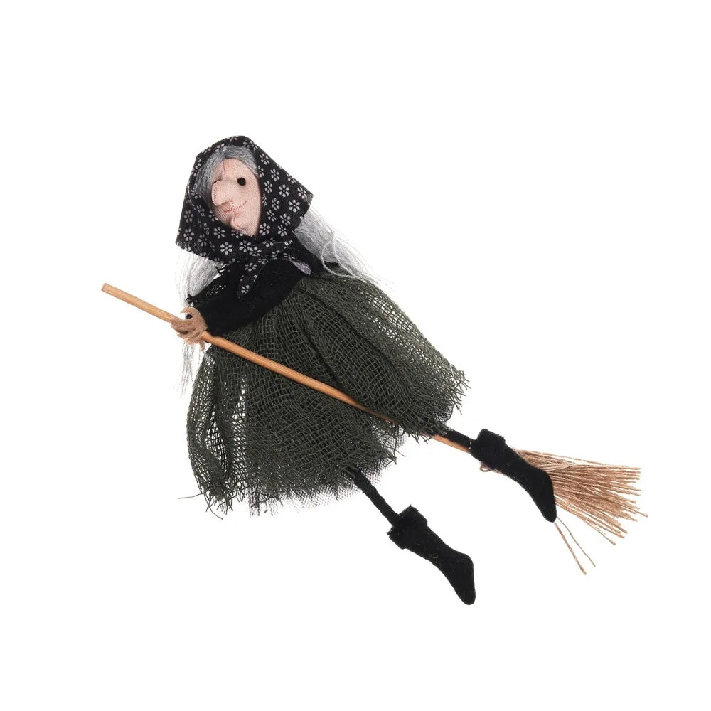 A scarecrow witch ornament featuring a burlap dress, black shawl, and straw broom.