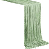 A light sage green semi-sheer gauze table runner draped in vertical folds.