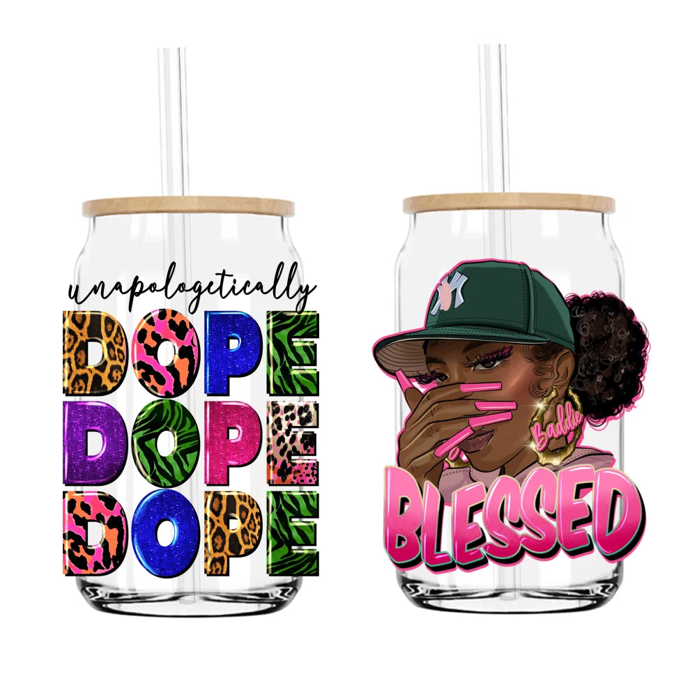 A clear tumbler with a black and gold design featuring the text Blessed and a woman wearing a green cap.