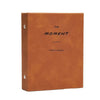A brown leather-bound photo album titled The Moment Photo Album with a simple line separator.