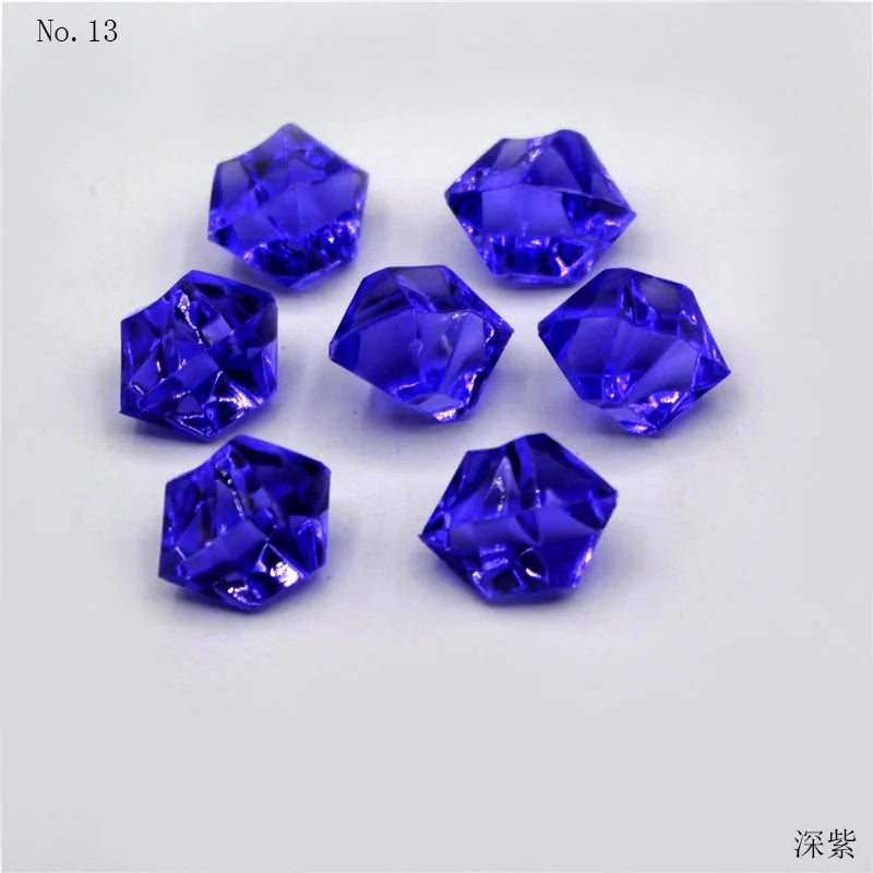 A collection of thirteen faceted, deep blue crystal ice cube acrylic stones for decorative use.