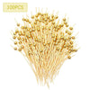 A bundle of 100 gold accent bamboo cocktail skewers for appetizers and fruit.