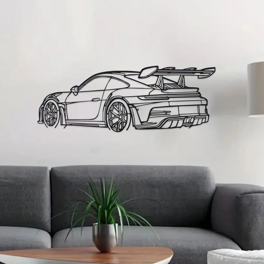 Black sports car metal wall art featuring a sleek modern design displayed above a gray sofa.