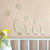 Handcrafted wooden goose wall art with floral accents displayed on a pink wall above a white railing.