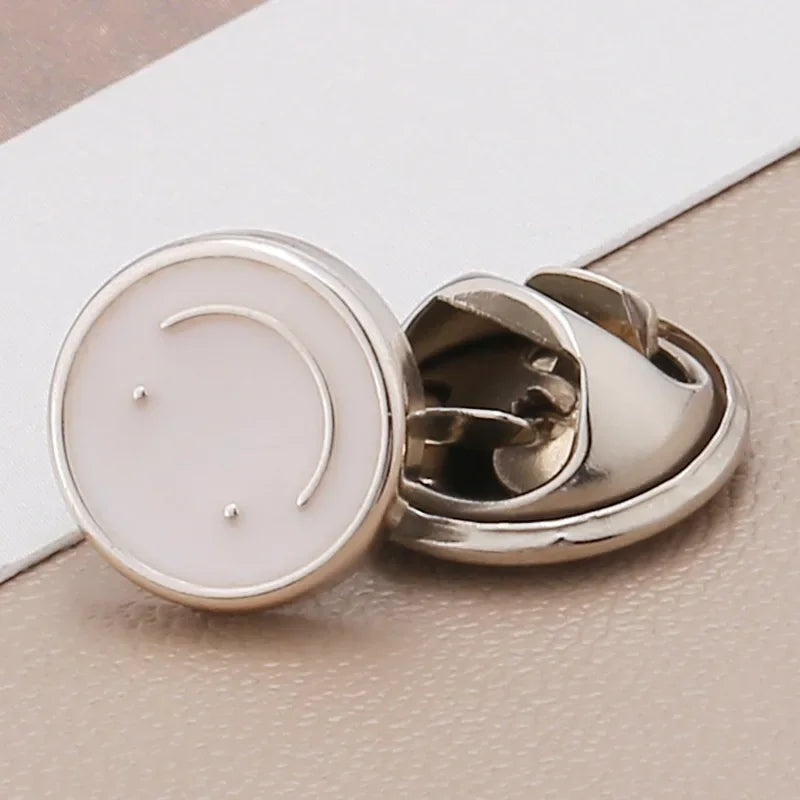 Silver no-sew brooch buttons with white pearl accents shown on a light background.