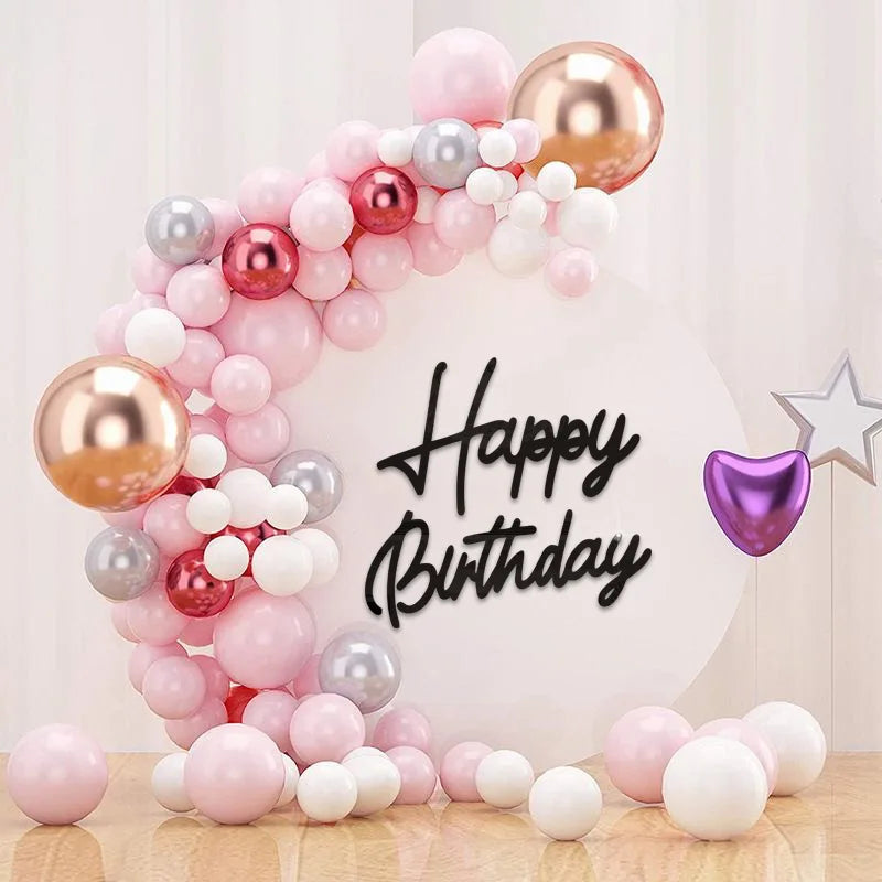 A balloon arch decoration featuring pink, silver, and gold balloons for a birthday party backdrop.