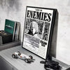 A framed poster featuring a character from Vinland Saga anime, displayed on a gray shelf.