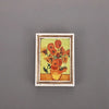 A framed painting featuring vibrant orange and yellow flowers in a classic style, suitable for fridge decor.