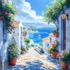 A sunny pathway lined with potted flowers leads through white stucco buildings and overlooks a blue sea.