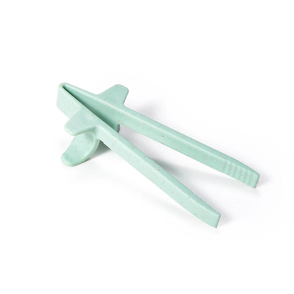A pair of light green reusable wheat straw finger chopsticks shown diagonally against a white background.