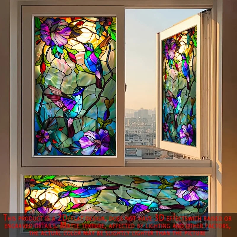 A close-up view of a stained glass window featuring colorful hummingbirds and floral designs.