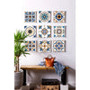 A display of various patterned self-adhesive tile wall stickers on a white wall, next to a wooden shelf.