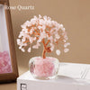 A delicate Rose Quartz money tree ornament featuring pink crystal blossoms on a wooden branch.