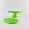 A set of two bright lime green cupcake stands with scalloped edges and a textured green base.