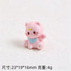 Pink cat resin keychain with a blue collar and yellow facial markings