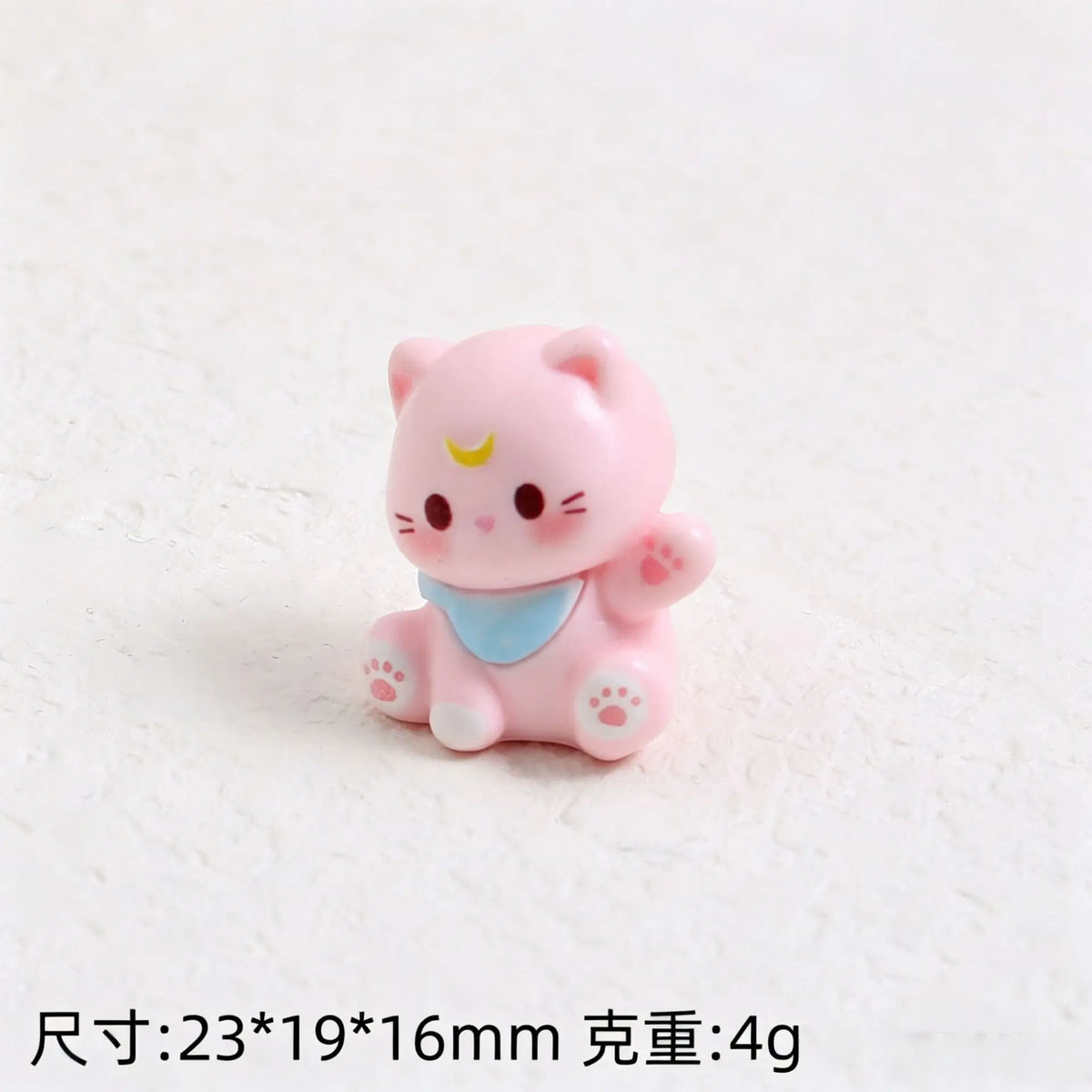 Pink cat resin keychain with a blue collar and yellow facial markings