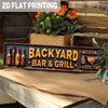 A wooden sign with carved lettering reads Backyard Bar & Grill placed on a rustic table.