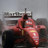 A red Formula 1 racing car is visible in a misty environment.