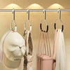 A display of circle ring hat hangers hanging from a bar, showing various hats and accessories.